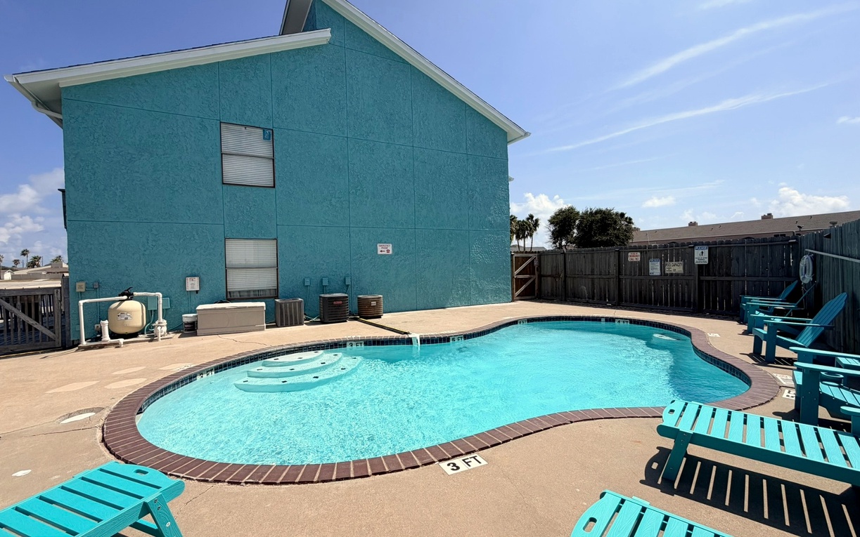 Private pool oasis with turquoise waters and bright blue chairs awaits your perfect beach getaway relaxation.
