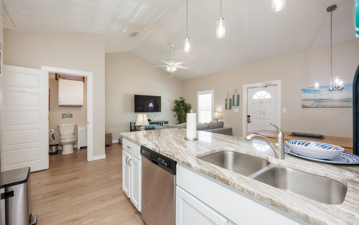 Your open-concept kitchen flows seamlessly into the living area, featuring granite counters and modern appliances for creating memorable meals together.