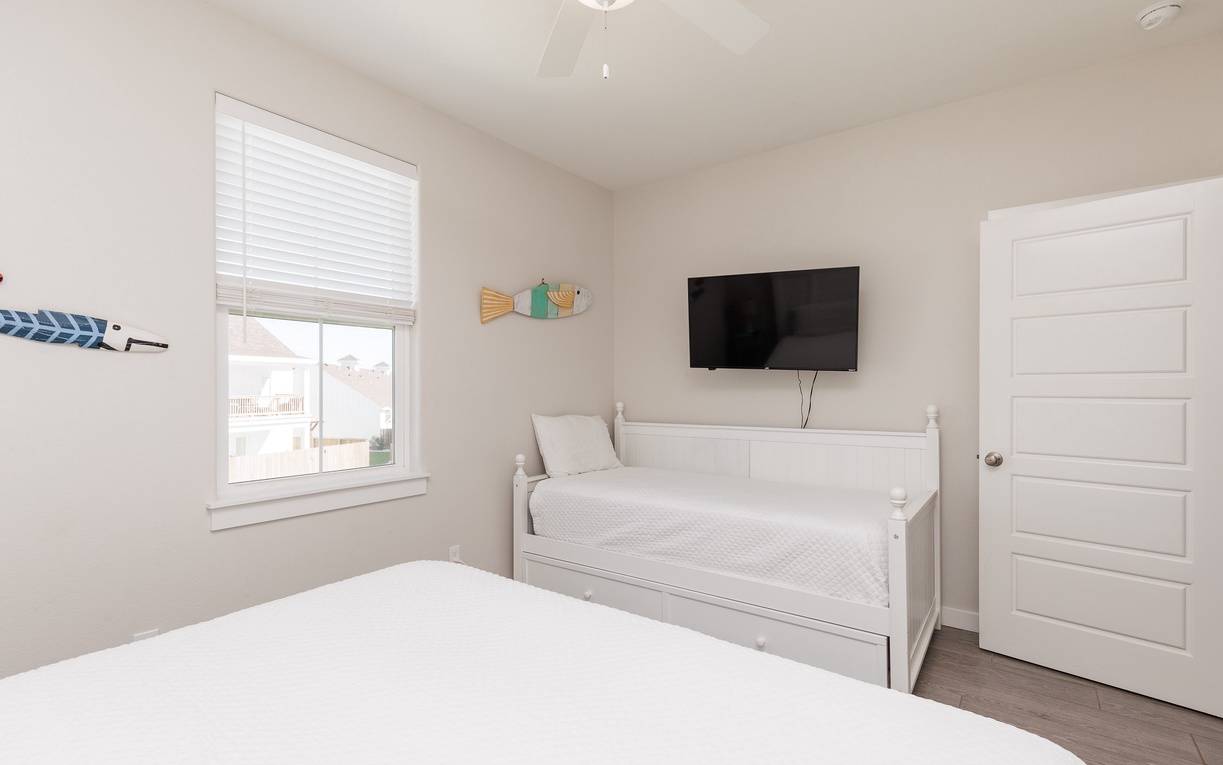 Relax in your serene bedroom with crisp white linens, coastal touches, and entertainment at your fingertips.