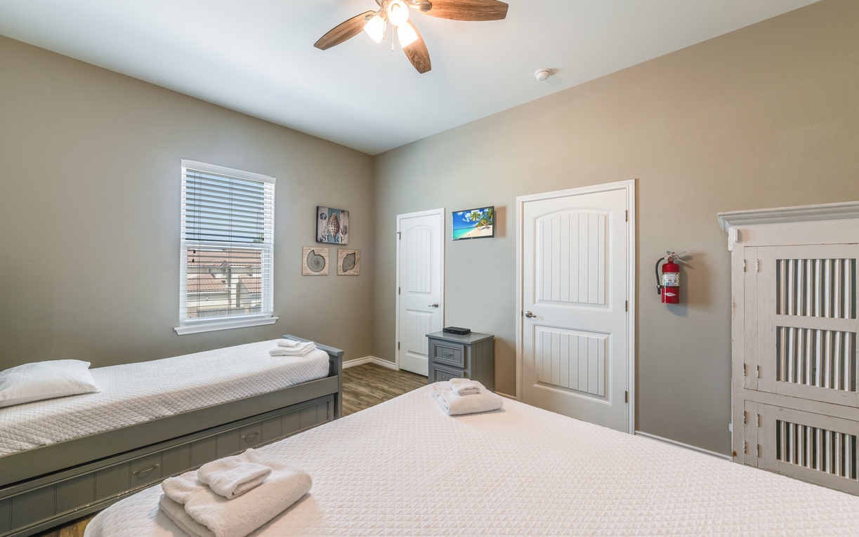 Rest peacefully in your comfortable twin bedroom with soft linens and gentle ceiling fan breeze keeping you cool.