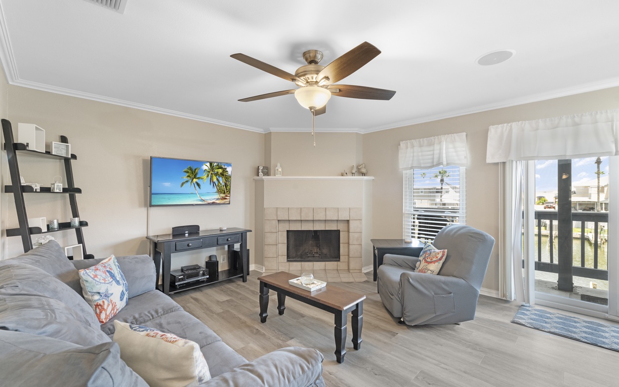 Relax in your inviting living room with cozy seating, fireplace warmth, and entertainment center for perfect vacation evenings.