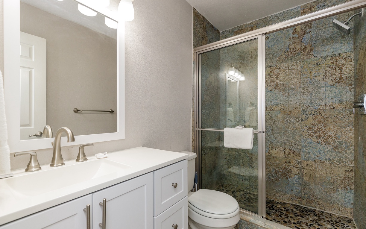 Your private bathroom features a luxurious stone-tiled shower and elegant vanity where you can refresh after your daily adventures.