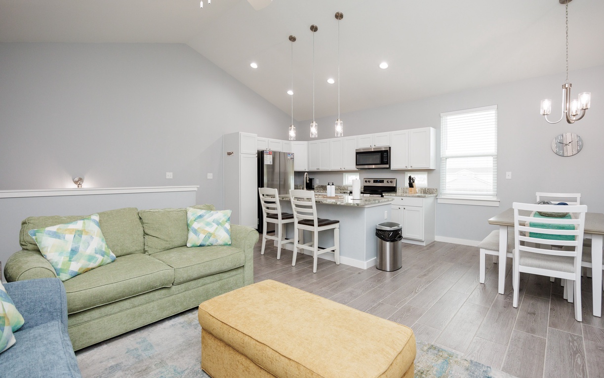 Relax in your bright open-plan space where cozy living flows into a fully equipped kitchen—perfect for memorable meals and quiet evenings.