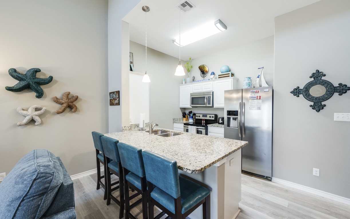 Your fully equipped kitchen invites morning coffee rituals and meal prep, with granite countertops and modern appliances creating the perfect culinary retreat.