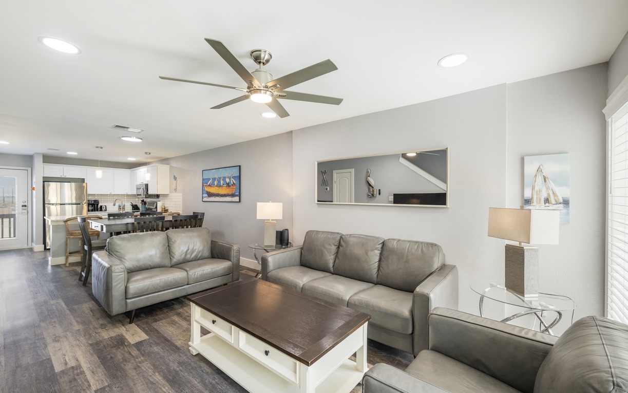 Relax in your spacious living area with comfortable leather seating, perfect for unwinding after exploring the coast.