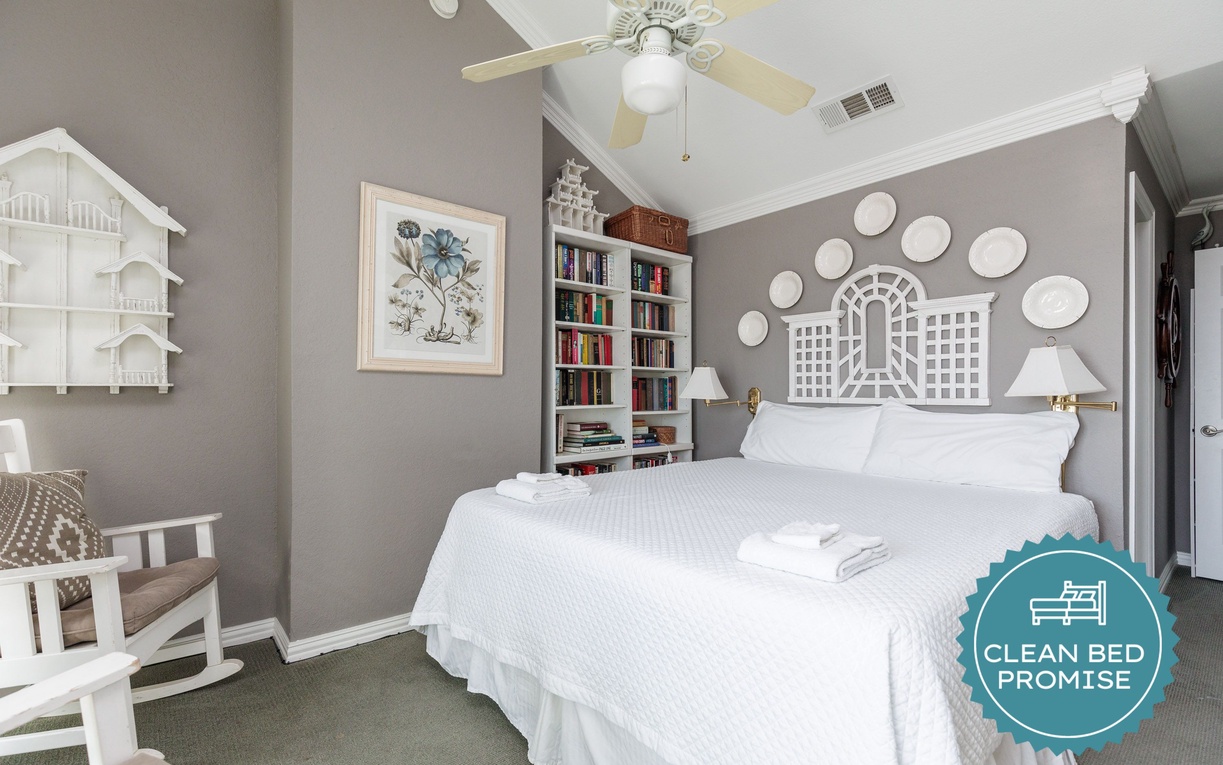 Sink into crisp white linens in your thoughtfully designed bedroom, where built-in bookshelves and warm reading lights create the perfect bedtime sanctuary.