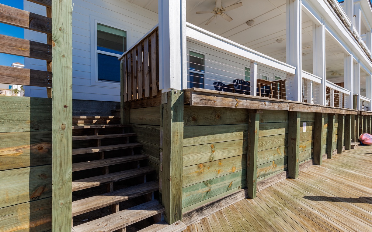 Beautiful elevated deck with covered porch where you can relax and enjoy coastal breezes from comfortable outdoor seating.