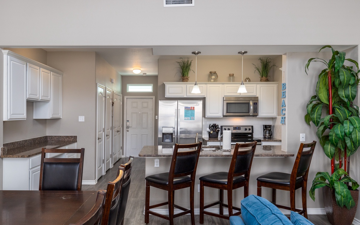 Your open kitchen features stainless appliances, granite counters, and breakfast bar seating for memorable meals together.