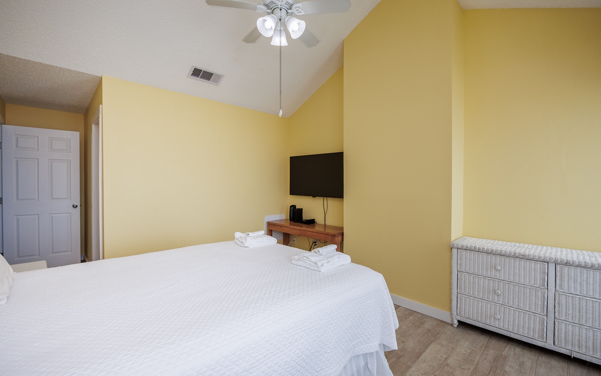 Unwind in your sunny bedroom with vaulted ceilings, plush bedding, and entertainment at your fingertips.