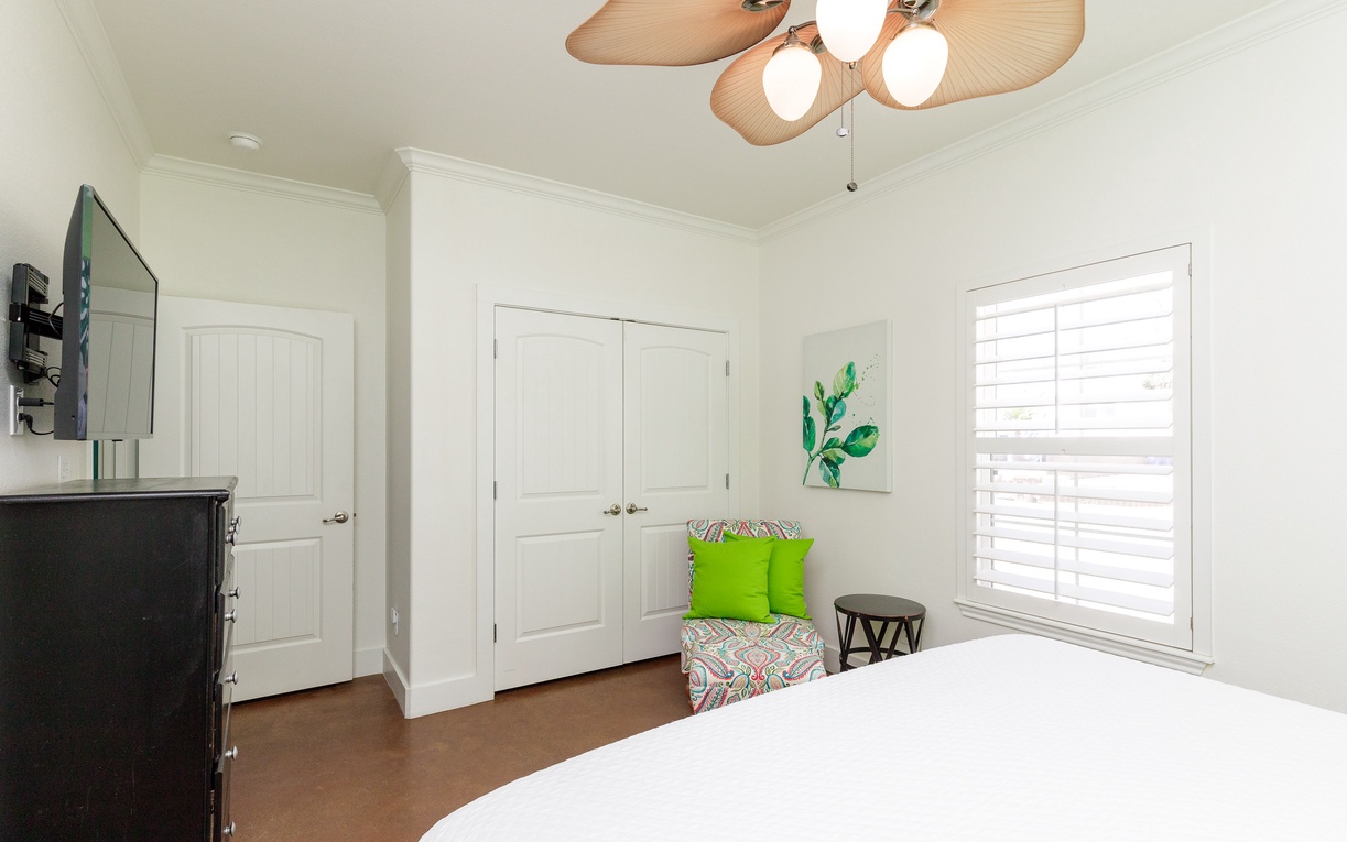 Relax in your bright bedroom with plush bedding, and king size bed.