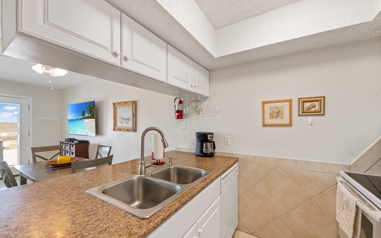 Your fully equipped kitchen awaits with granite counters, stainless sink, and coffee maker ready for morning brews and vacation cooking.
