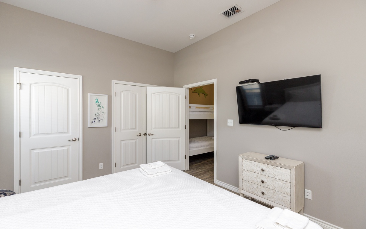 Your peaceful bedroom features a wall-mounted TV and built-in bunk beds, perfect for family stays with comfort and entertainment.