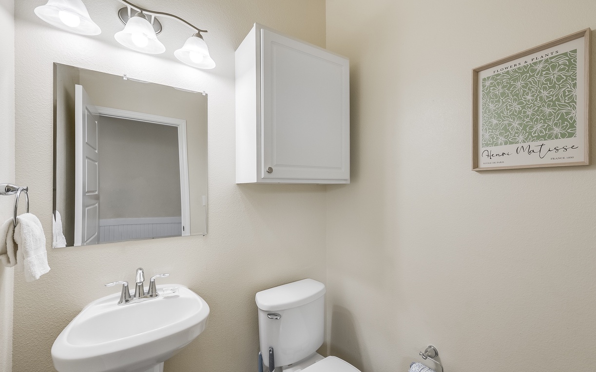 Your private half-bath features clean lines, modern fixtures, and thoughtful storage to keep you organized during your stay.