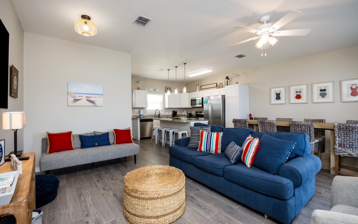 Relax in your open living space with comfortable seating, modern kitchen, and coastal touches throughout.
