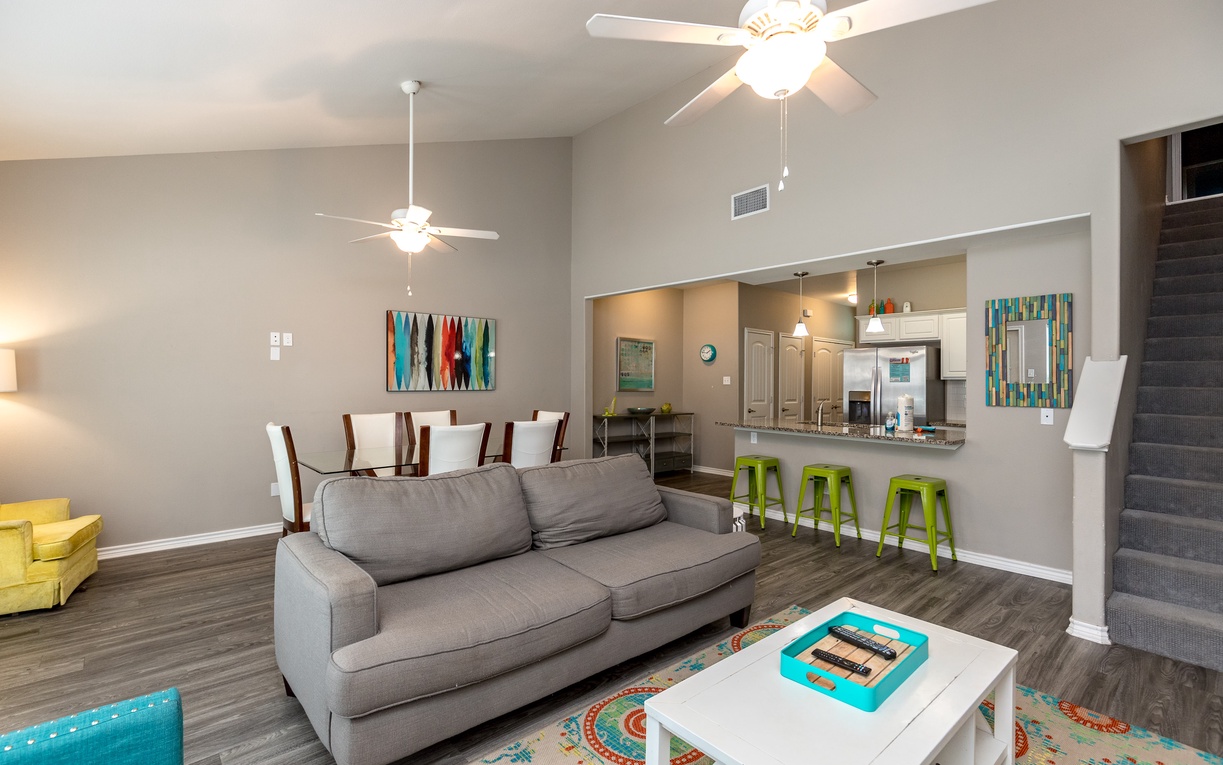 Relax in your bright open-concept living space with modern comfort and vibrant decor creating the perfect vacation home atmosphere.