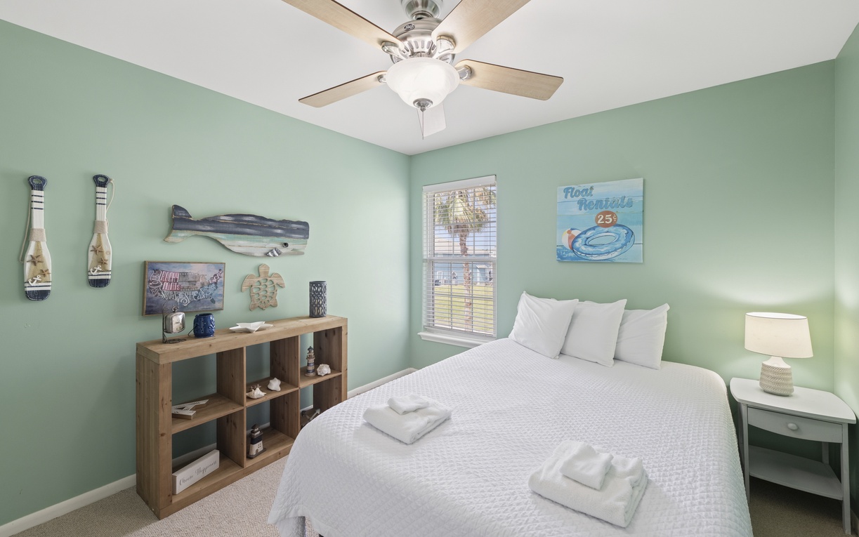 Sink into crisp linens in this soothing coastal bedroom, where gentle sea-glass walls and beachy décor create your tranquil escape. Your own ceiling fan keeps you comfortable year-round.