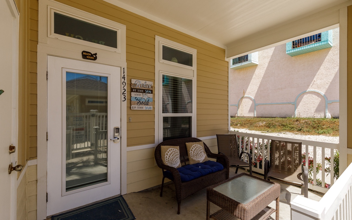 Settle into your private covered balcony with comfortable wicker seating, perfect for morning coffee or evening relaxation.
