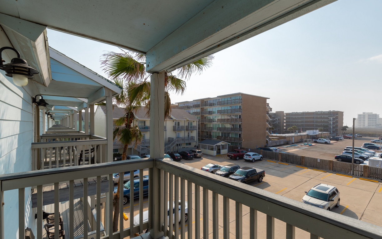 Step onto your covered balcony and take in the coastal views of nearby buildings and palm trees swaying in the ocean breeze.
