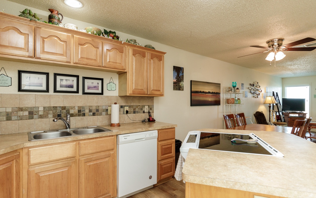 Your fully equipped kitchen features warm wood cabinets, granite countertops, and modern appliances for preparing memorable vacation meals together.