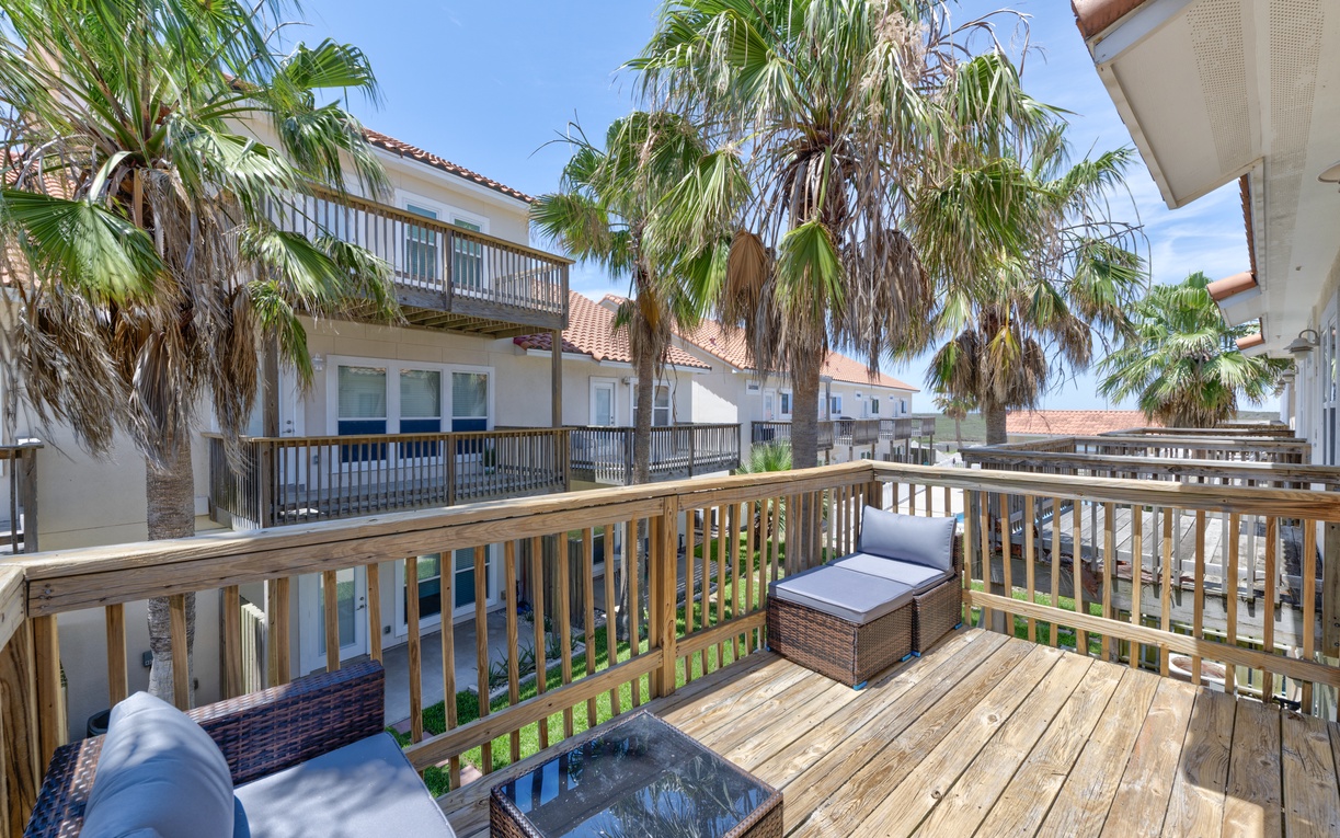 Sip your morning coffee on your private deck, shaded by swaying palms and framed by coastal charm—your peaceful outdoor retreat awaits.