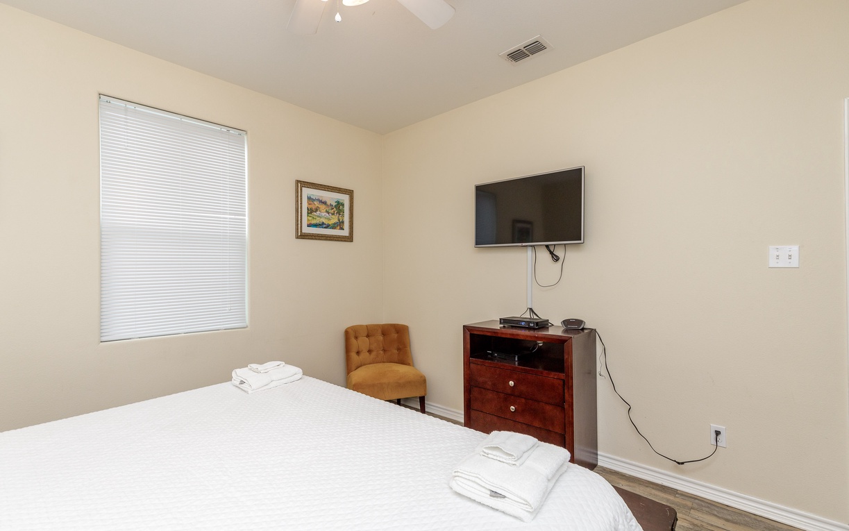 Rest easy in your peaceful bedroom with a flat-screen TV, comfy reading chair, and fresh towels awaiting your arrival.