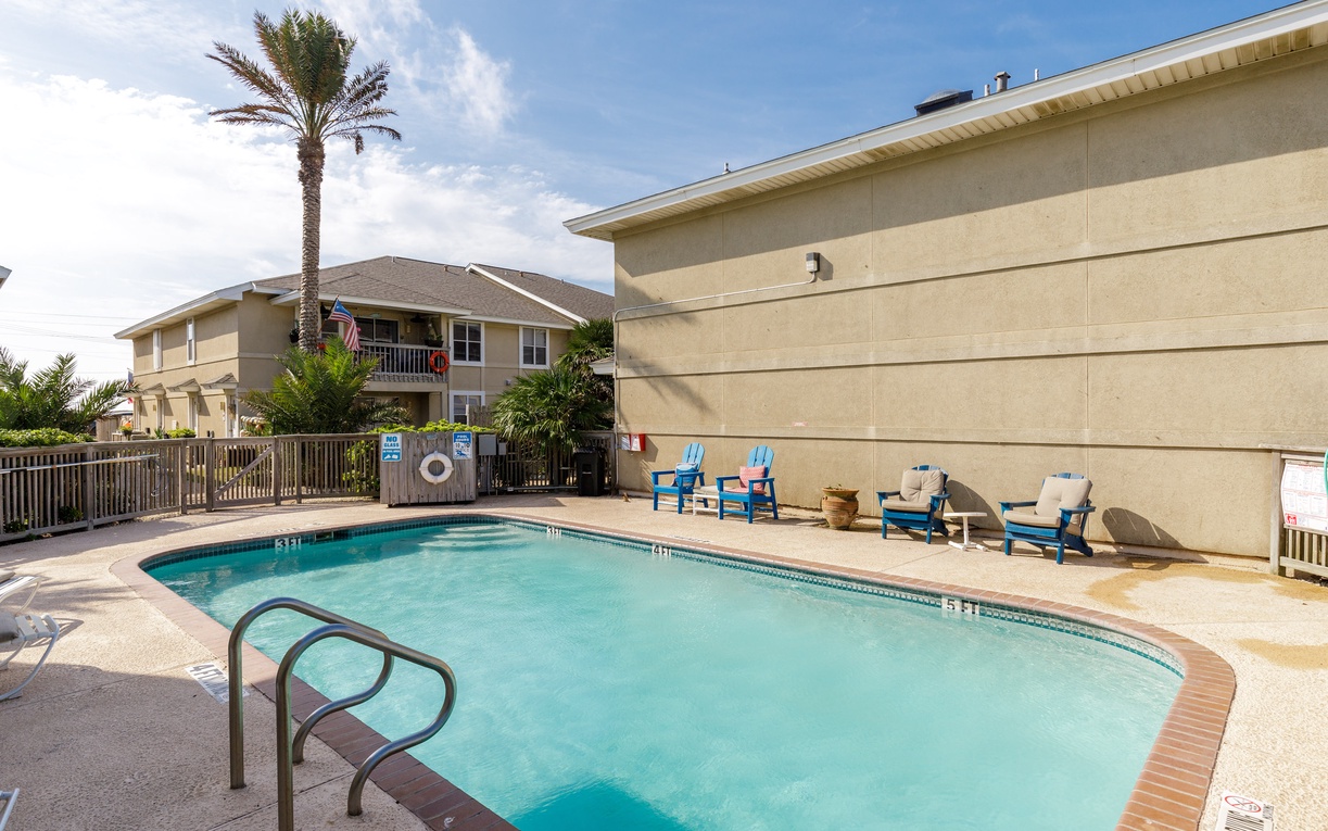Cool off in this inviting pool area surrounded by tropical palms and comfortable lounge chairs for your perfect sunny day retreat.