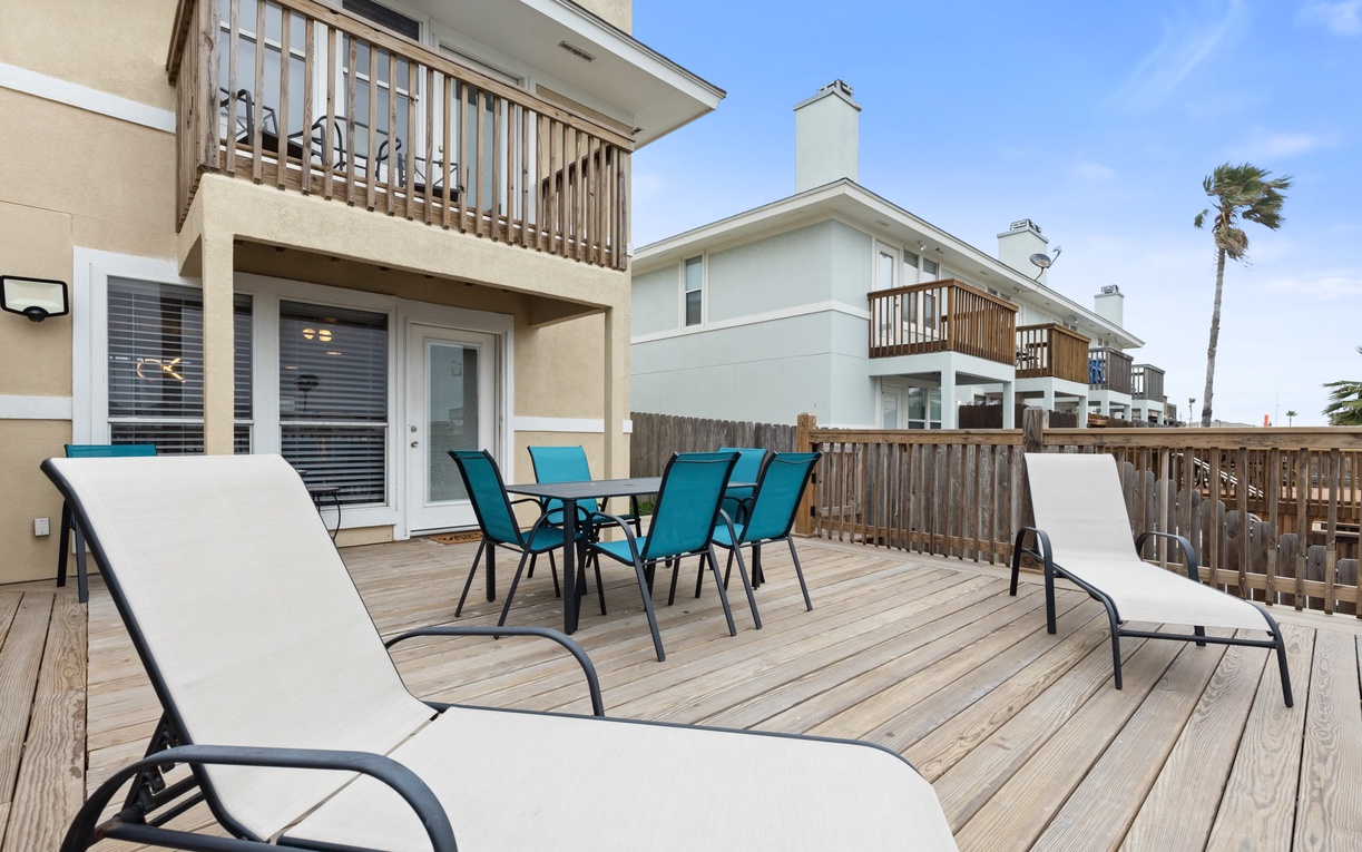 Unwind on your private deck with lounge chairs and dining space, perfect for morning coffee or evening cocktails under endless blue skies.