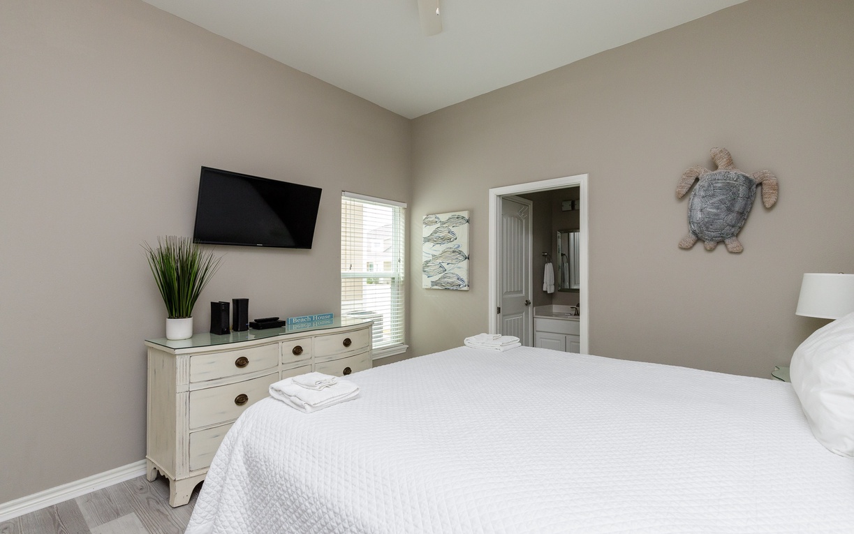 Unwind in your peaceful bedroom with coastal touches, plush bedding, and your own ensuite bathroom for ultimate comfort.