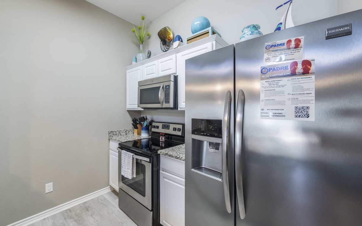 Step into your bright, open kitchen where granite counters and modern appliances await your culinary adventures.