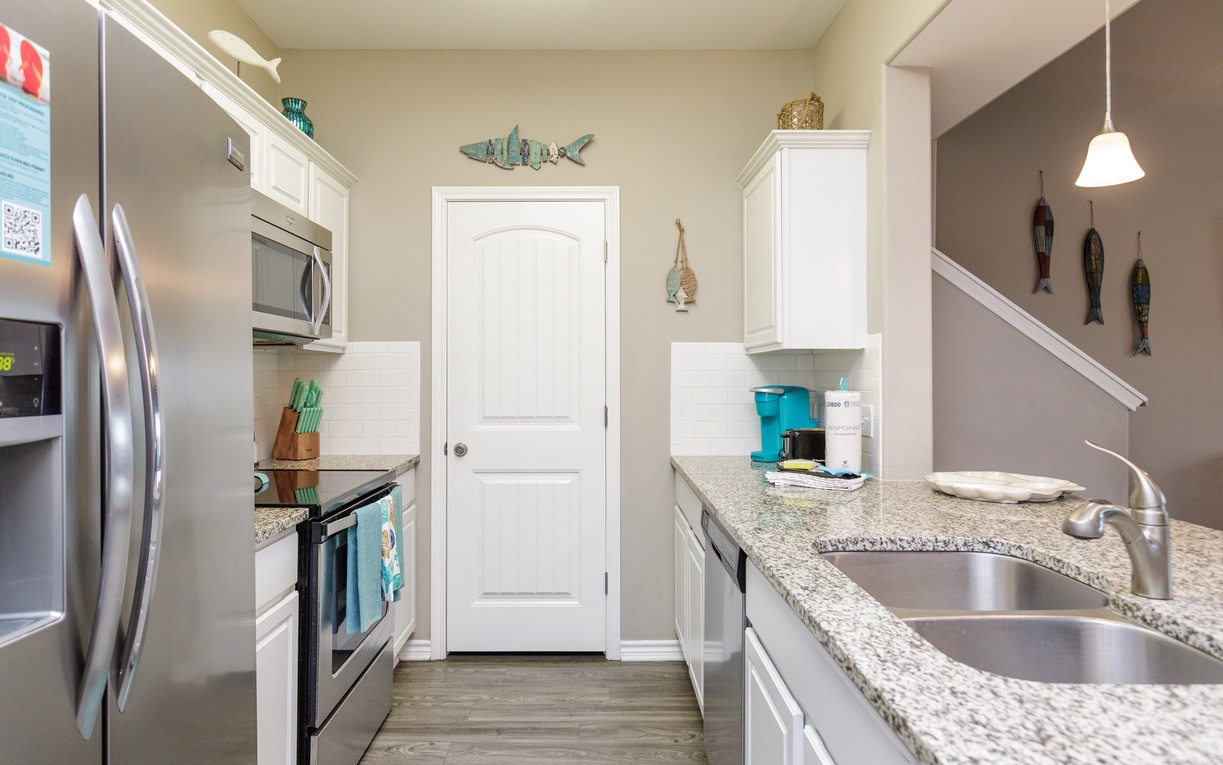 Cook your favorite meals in this fully-equipped kitchen with granite counters and modern appliances.