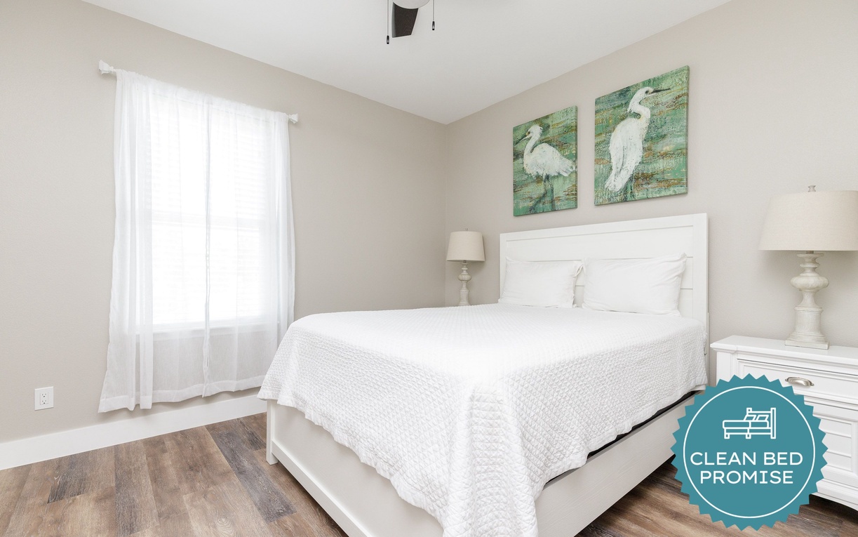 Drift off to sleep in this serene bedroom with crisp linens and coastal charm.