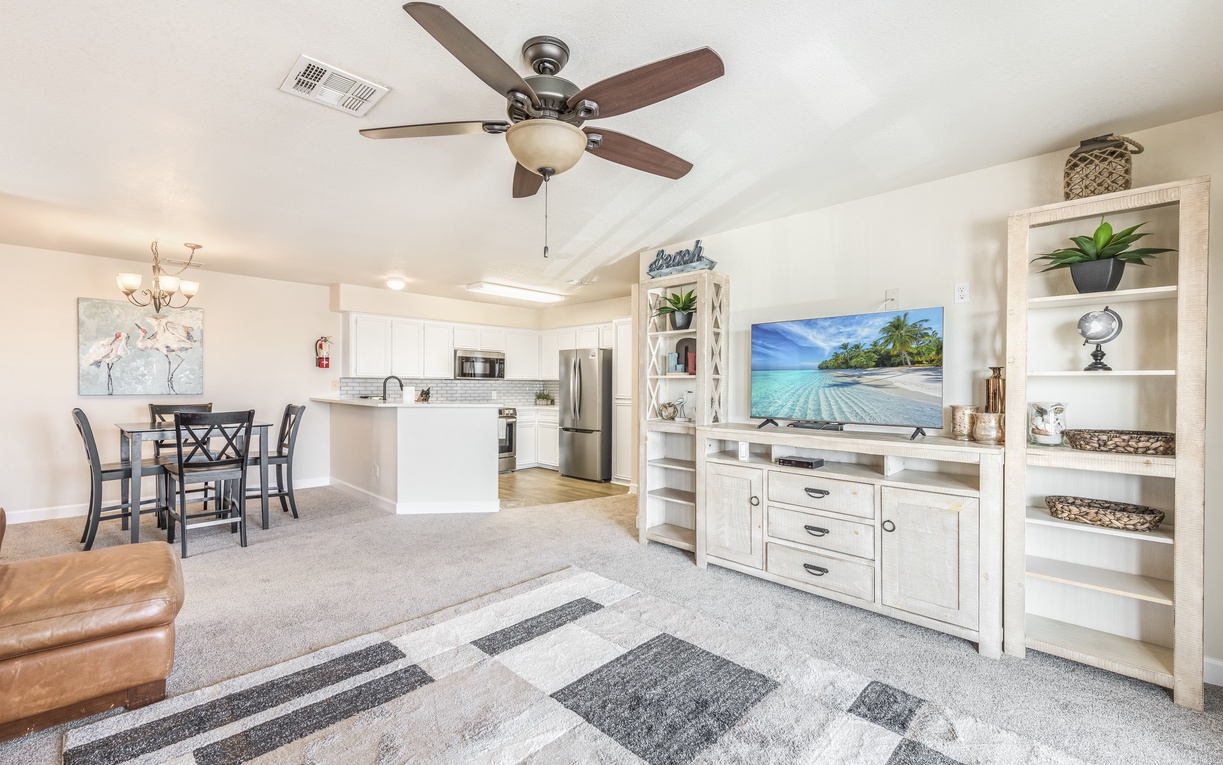 Relax in your bright, open living space with stylish coastal décor, modern kitchen, and tropical beach views on the big screen.