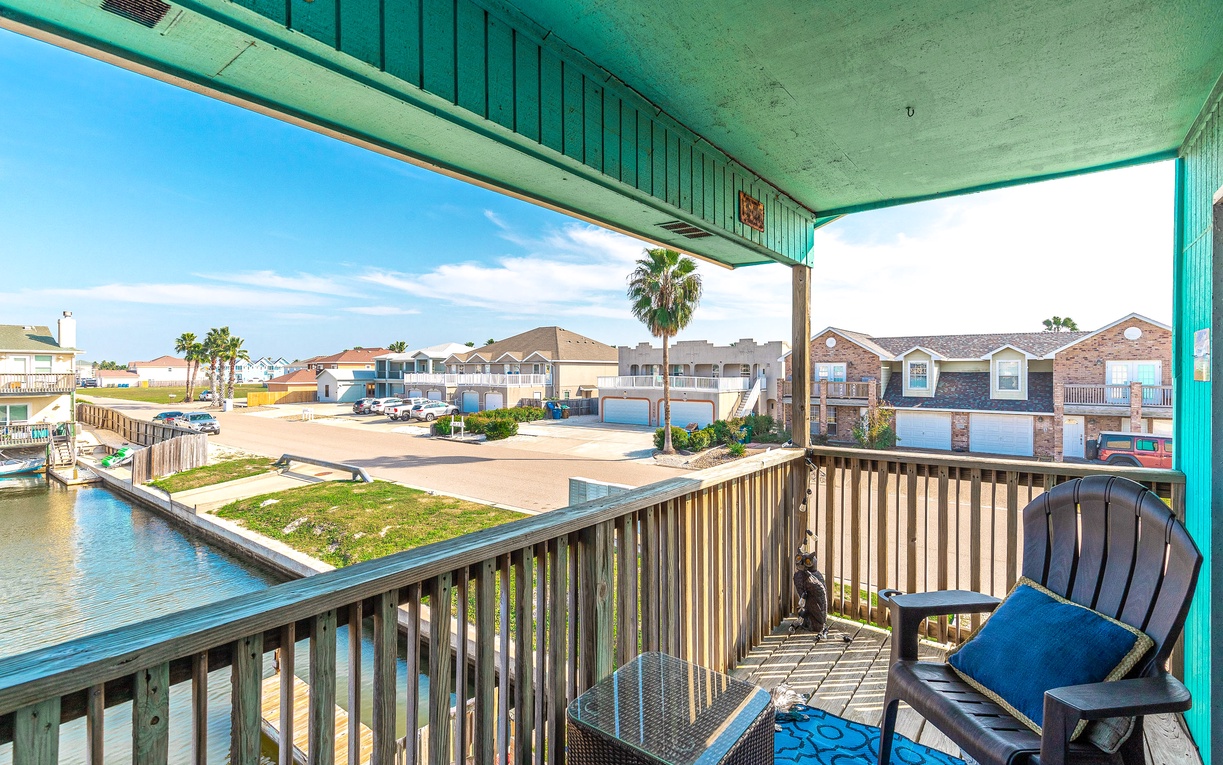 Relax on your covered balcony with comfortable seating and enjoy waterfront views of the peaceful canal neighborhood.