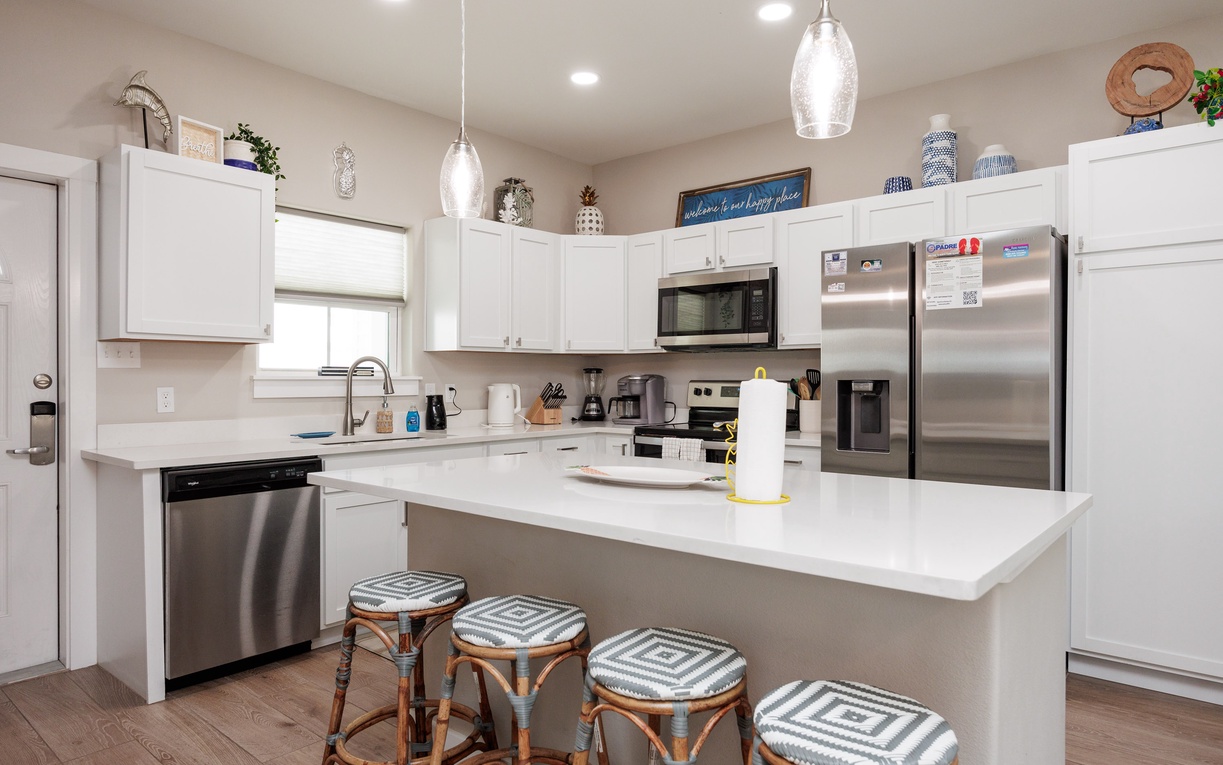 Your fully-equipped kitchen features stainless appliances, granite counters, and breakfast bar seating for four—perfect for group meals and morning coffee.