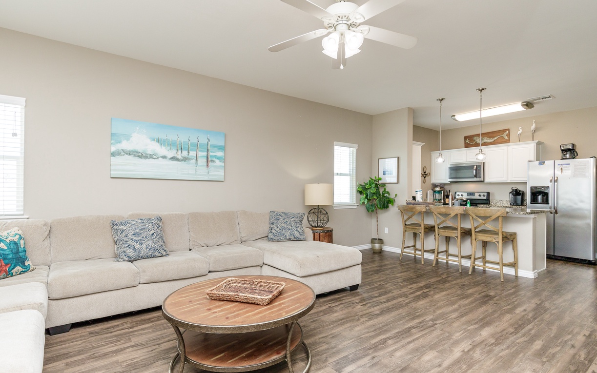 Unwind in your spacious open-plan living area with comfortable sectional seating and fully equipped kitchen—perfect for gathering with loved ones.