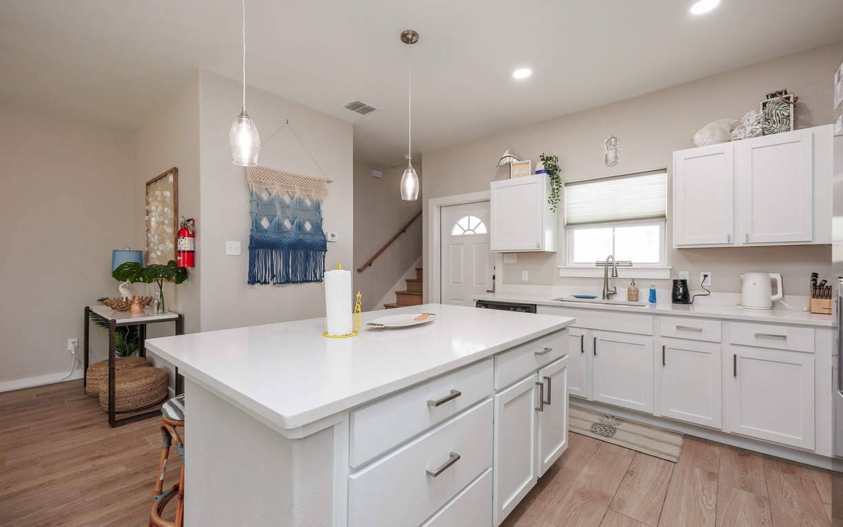 Your modern kitchen features bright white cabinets, a spacious island, and stylish pendant lighting for memorable meal prep.