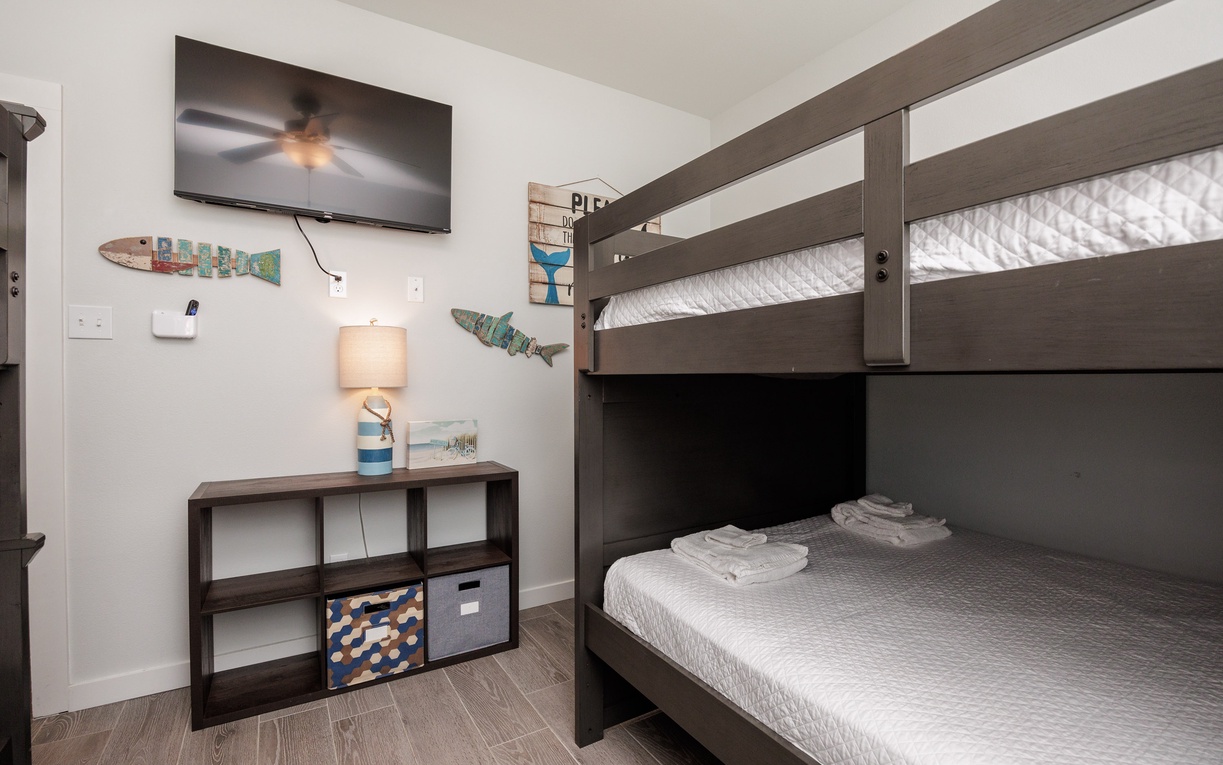Your kids will love this fun bunk bed setup with entertainment and storage space for all their vacation treasures.