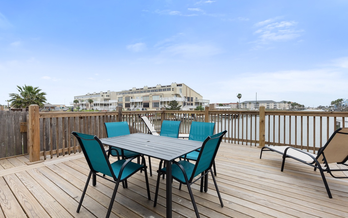 Spacious deck with dining table for six offers perfect spot for morning coffee or evening meals with coastal breeze.