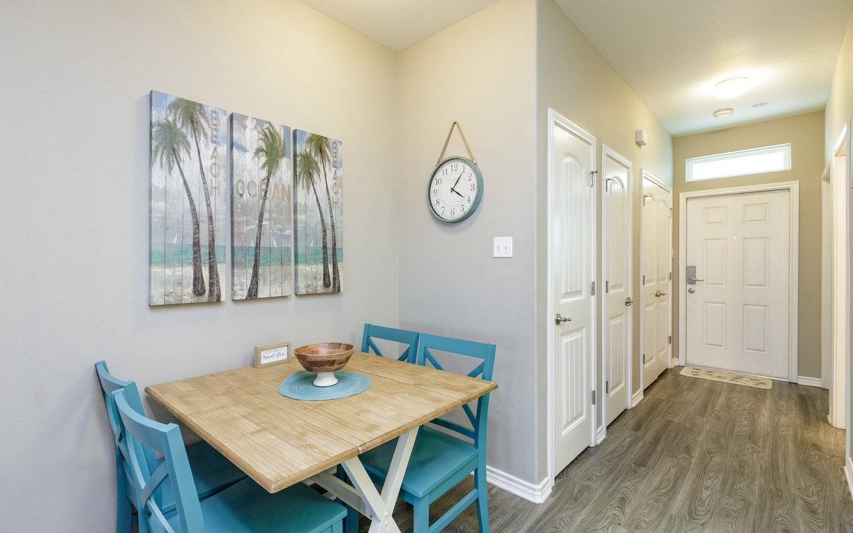 Gather around your bright coastal dining nook, where tropical artwork sets the mood for memorable meals together.