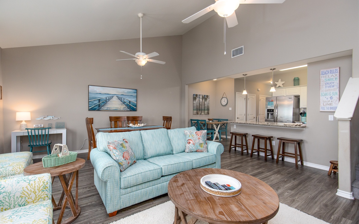 Unwind in your bright open-plan living space with coastal touches and a fully equipped kitchen for memorable vacation meals.