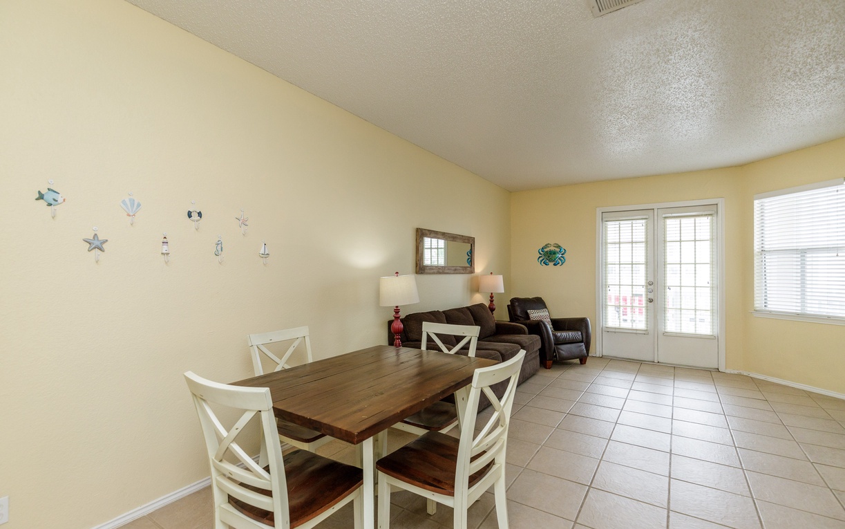 Gather around your dining table for memorable meals with charming nautical touches creating a warm coastal atmosphere.