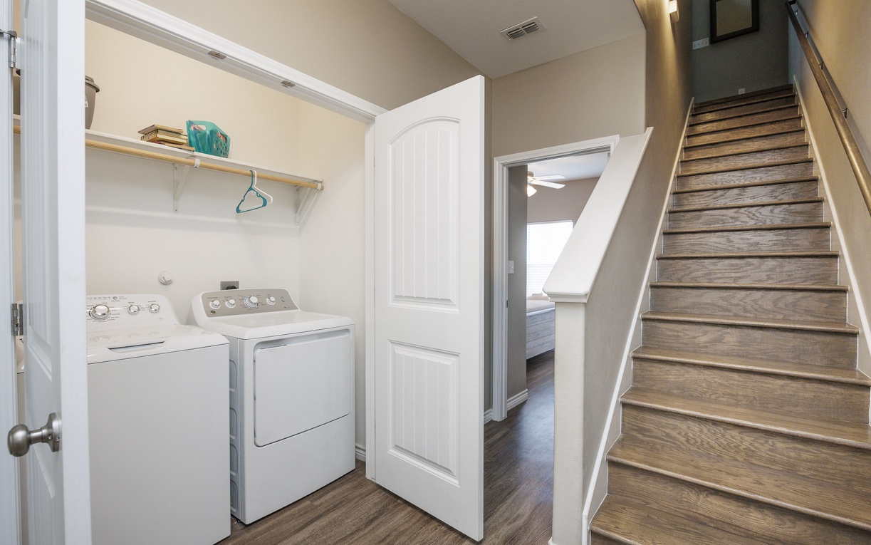 Your private laundry nook keeps everything tidy with full-size washer and dryer plus convenient hanging space.