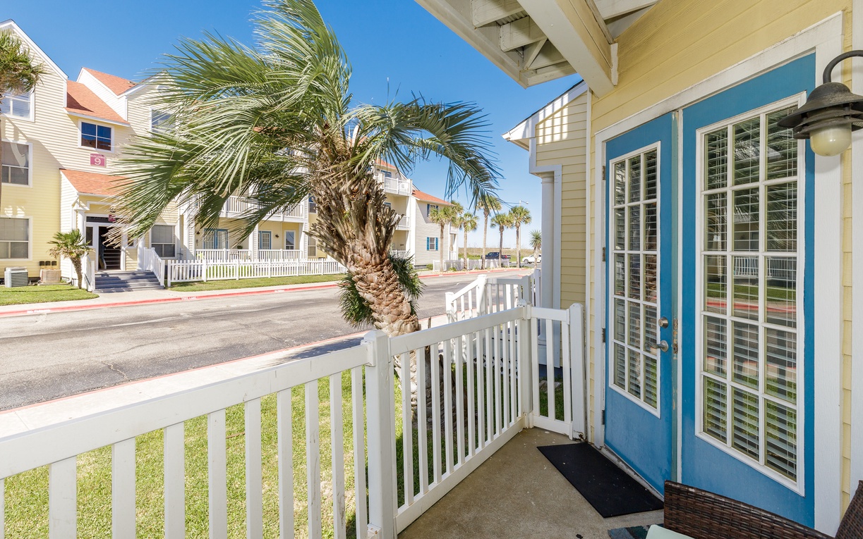 Step onto your private balcony and breathe in the coastal breeze while palm trees sway in this charming beachside neighborhood.