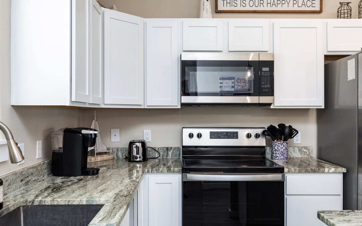 Your fully equipped kitchen with granite countertops and modern appliances makes meal prep a breeze during your stay.