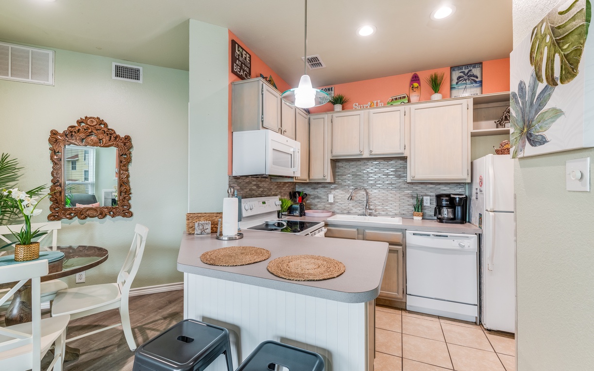 Your stylish kitchen features modern appliances, tropical touches, and a breakfast bar perfect for morning coffee conversations.