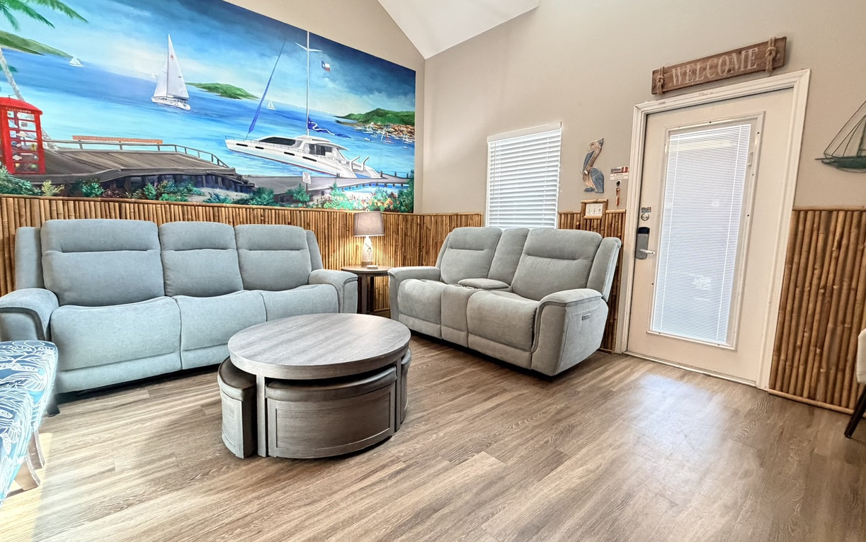 Relax in your coastal-themed living room with plush seating and tropical wall art that transports you to paradise.