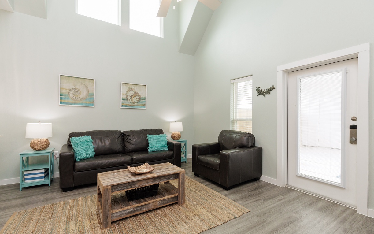 Relax in your bright living space with comfortable leather seating and coastal touches throughout.