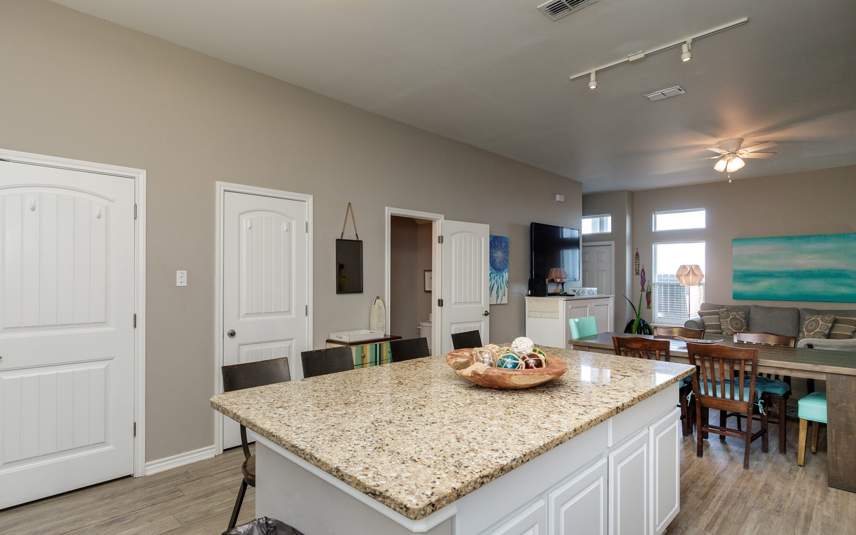 Your spacious kitchen flows seamlessly into the dining area, perfect for preparing meals and gathering together.