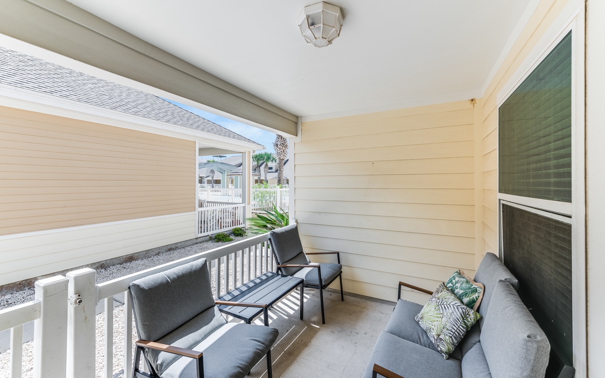 Unwind on your private covered balcony with comfortable seating and natural light streaming through.