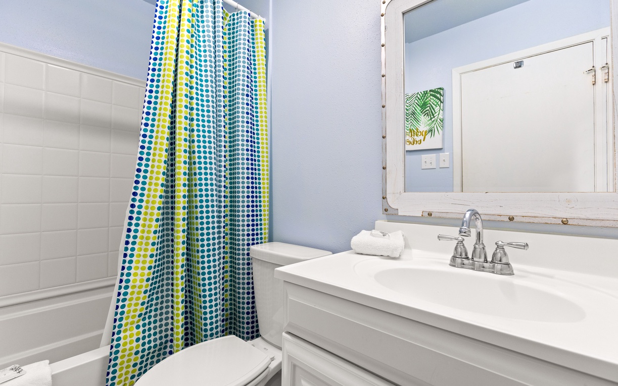 Refresh in your bright, cheerfully decorated bathroom with colorful polka-dot shower curtain and fresh towels ready for your stay.